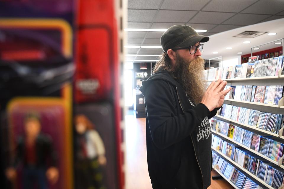 Grindhouse Video owner Mike Sandlin stands in the aisles at Grindhouse Video in West Knoxville, Wednesday, Sept. 28, 2022. Sandler moved the store from Tampa, Florida earlier this year.