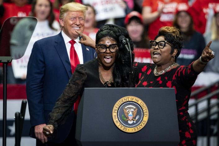 Social Media influencers and video bloggers Lynnette &quot;Diamond&quot; Hardaway, center, and Rochelle &quot;Silk&quot; Richardson, right, speak as U.S. President Donald Trump smiles during a rally in Charlotte, North Carolina, on Monday, March 2, 2020. Trump told reporters in the Oval Office on Monday that holding campaign rallies with thousands of attendees is &quot;very safe&quot; despite recent cases of the virus in the U.S. Photographer: Al Drago/Bloomberg via Getty Images
