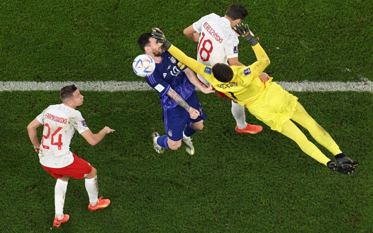 Lionel Messi of Argentina is fouled by Wojciech Szczesny of Poland which leads to a penalty during the FIFA World Cup Qatar 2022 Group C match between Poland and Argentina at Stadium 974 on November 30, 2022 in Doha, Qatar