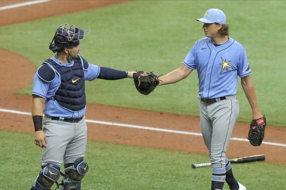 Tampa Bay Rays' Tyler Glasnow, right, bumps fists with catcher Mike Zunino after pitching during baseball practice Tuesday, July 14, 2020, in St. Petersburg, Fla. (AP Photo/Mike Carlson)