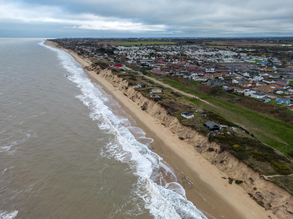 Properties sit close to the edge of the shoreline after erosion swept away large parts of the beach, on February 28, 2023 in Hemsby. (Getty)