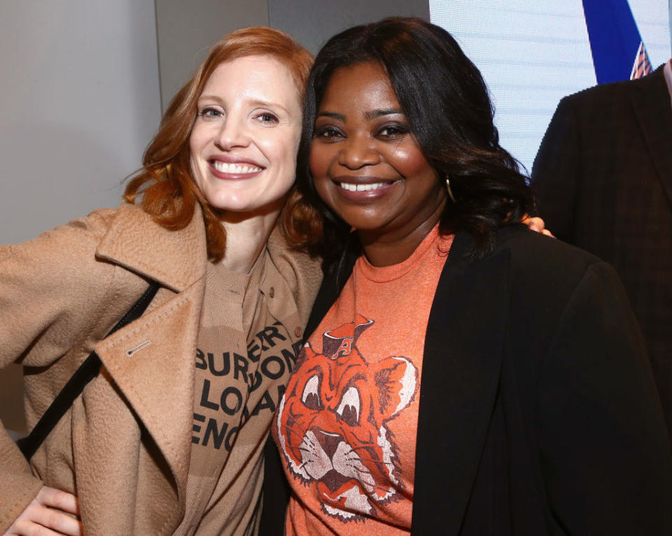 dressed casually in t-shirts and winter coats, the actors get close to pose for a picture