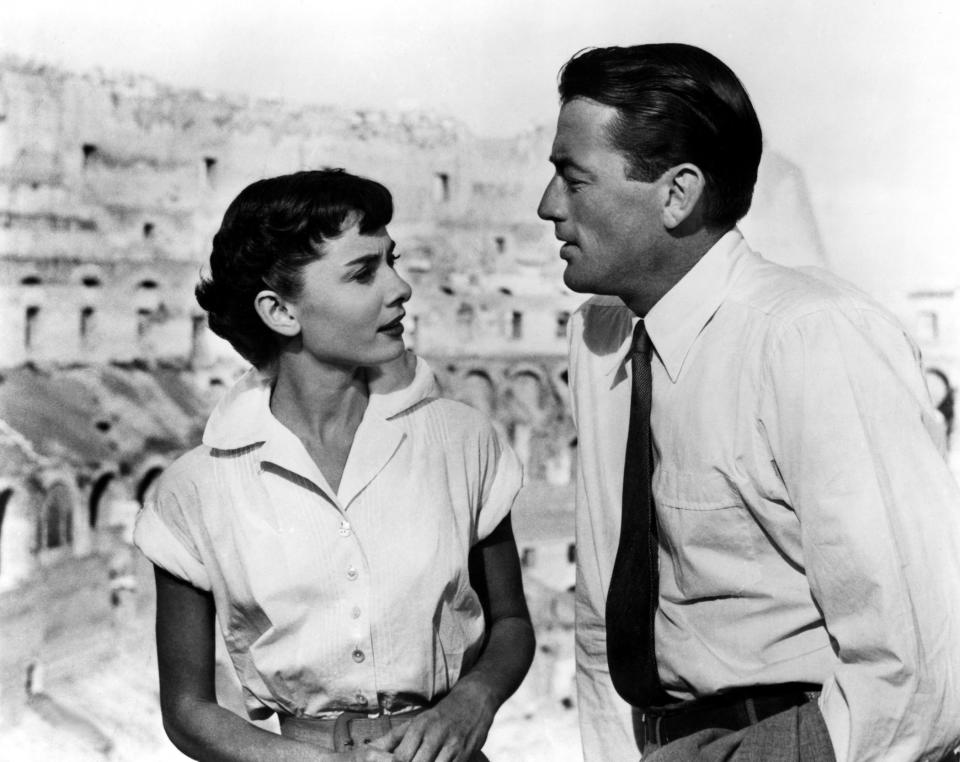 Audrey Hepburn and Gregory Peck talking at the Colosseum.