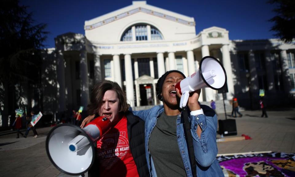 Oakland Unified School District teachers use bullhorns as they picket outside of Oakland Technical High School.