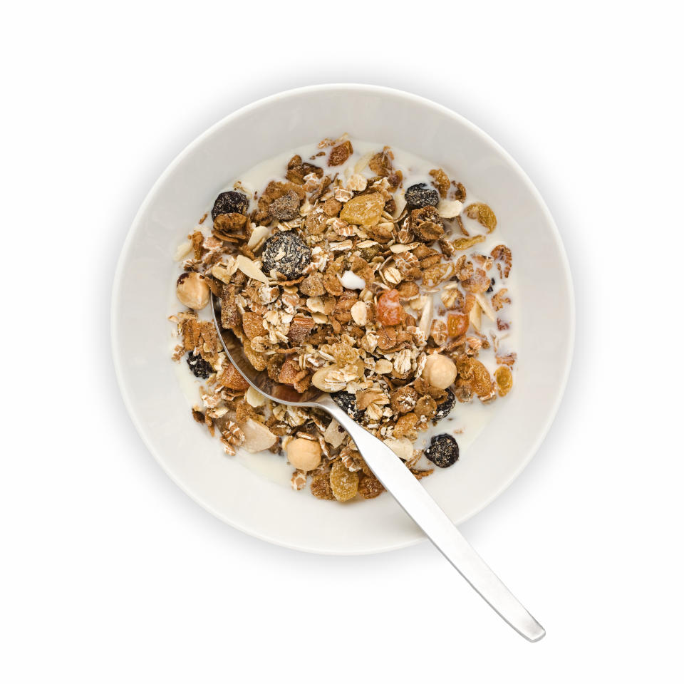 Cut out of overhead view of Bowl of Muesli with milk and spoon