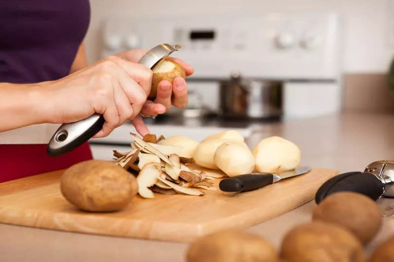 Woman peeling potatoes