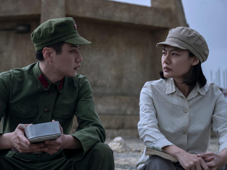 yang weining and ye wenjie sitting outside in three body problem, wearing utilitarian clothing