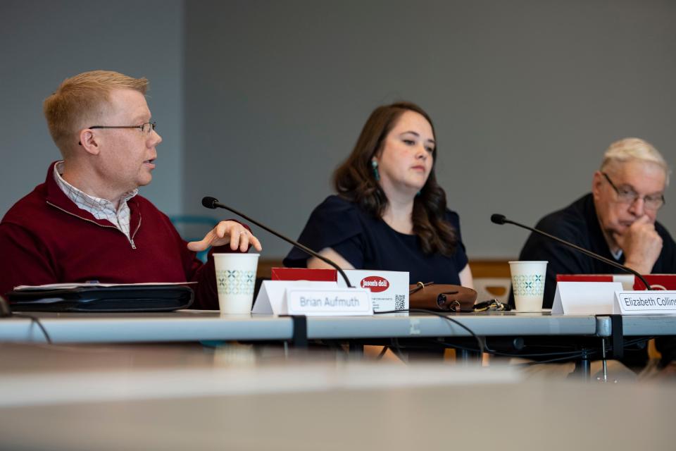 The Greenville County Library Board member Brian Aufmuth, left, speaks as Elizabeth Collins, center, and Tommy Hughes, right, listen on during a meeting to discuss reading materials available at the library at Hughes Main Library on Friday, Feb. 16, 2024.
