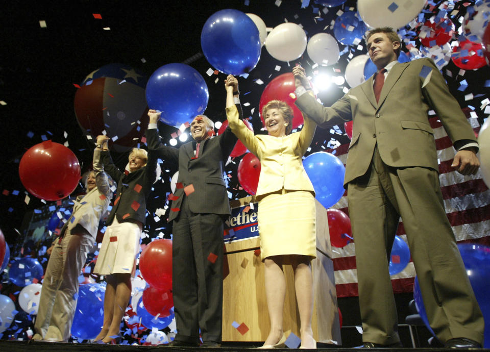 FILE - Rep. George Nethercutt, R-Wash., center holds hands with his wife Mary Beth, second from left, and North Carolina Sen. Elizabeth Dole, second from right, along with Nethercutt's daughter Meredith, far left, and son Elliott, far right, May 14, 2004, after Nethercutt officially announced his campaign for the U.S. Senate in Bellevue, Wash. Nethercutt, who was a Spokane lawyer with little political experience when he ousted Democratic Speaker of the House Tom Foley as part of a stunning GOP wave that shifted national politics to the right in 1994, died Friday, June 14, 2024, near Denver. He was 79. (AP Photo/Ted S. Warren, File)