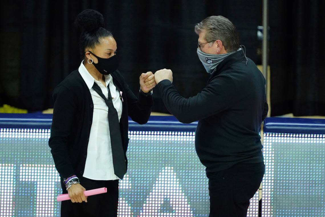 Connecticut head coach Geno Auriemma, right, and South Carolina head coach Dawn Staley, left, meet before an NCAA college basketball game in Storrs, Conn., Monday, Feb. 8, 2021.