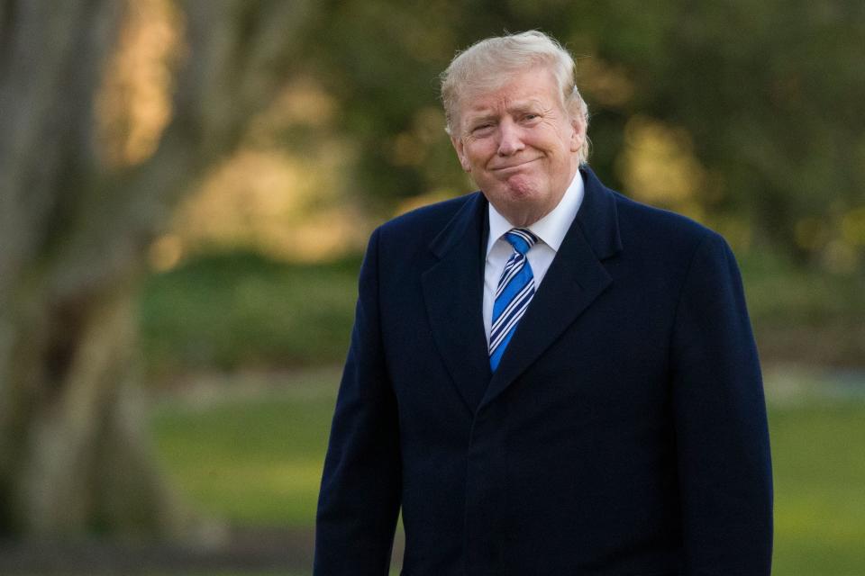 President Donald Trump smiles as he walks on the South Lawn after stepping off Marine One at the White House, March 10, 2019, in Washington.