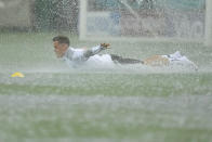 Austria's Christoph Baumgartner takes a dive on the pitch during a heavy rainfall before a training session at the National Arena stadium in Bucharest, Romania, Saturday, June 12, 2021, the day before their first match against North Macedonia. (AP Photo/Vadim Ghirda)