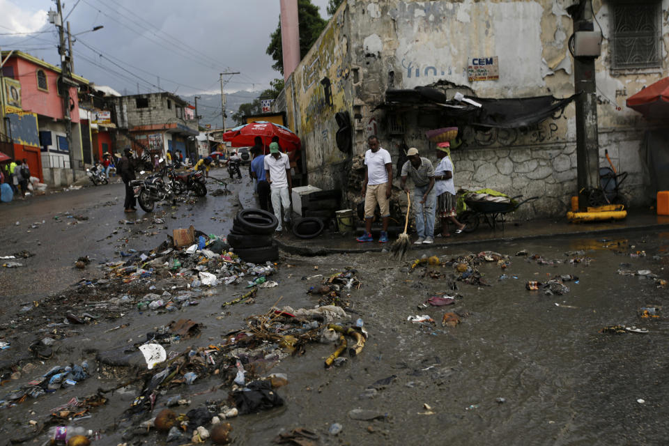 Debris litters a street caused by a flood of water brought on by heavy rains that fell over Port-au-Prince, Haiti, Friday, July 9, 2021, two days after Haitian President Jovenel Moise was assassinated in his home. (AP Photo/Fernando Llano)