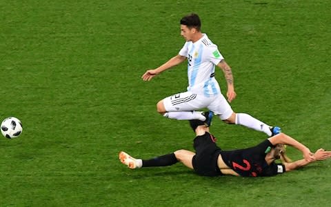  Domagoj Vida holds up the run of Cristian Pavon - Credit: MARTIN BERNETTI/AFP/Getty Images