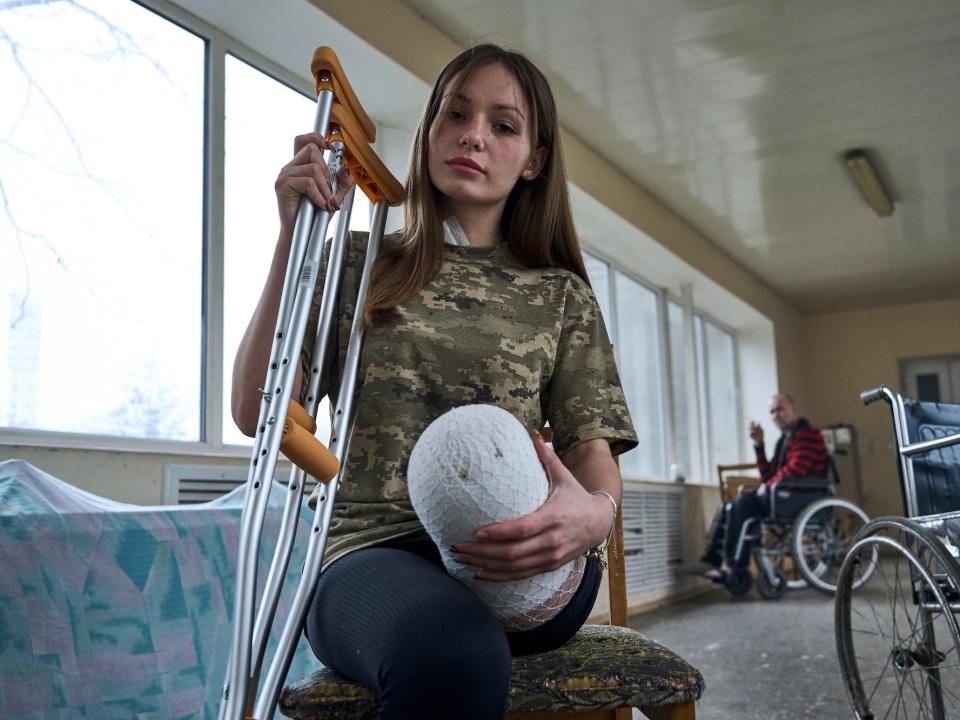 Ruslana Danylkina, 19, a Ukrainian soldier who lost her leg in the fighting near Kherson, holds her crutches in a city hospital in Odesa, Ukraine, Feb. 27, 2023.