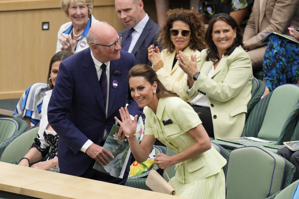 Kate, Princess of Wales waves as she arrives in the Royal Box with AELTC chairman Ian Hewitt ahead of the final of the women's singles between the Czech Republic's Marketa Vondrousova and Tunisia's Ons Jabeur on day thirteen of the Wimbledon tennis championships in London, Saturday, July 15, 2023. (AP Photo/Kirsty Wigglesworth)