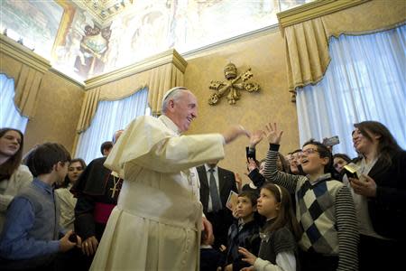 Pope Francis blesses youths of the "Azione Cattolica" organization during a private audience at the Vatican December 20, 2013. REUTERS/Osservatore Romano