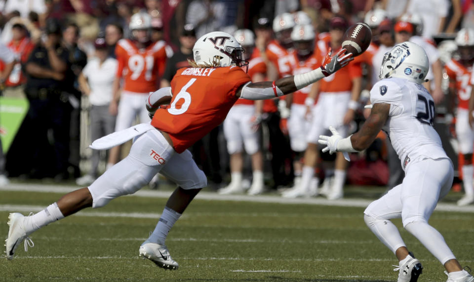 Virginia Tech's Hezekiah Grimsely, left, nearly intercepts a pass intended for Old Dominion's Justice Davila during the first half of an NCAA college football game Saturday, Sept. 22, 2018, in Norfolk, Va. (AP Photo/Jason Hirschfeld)