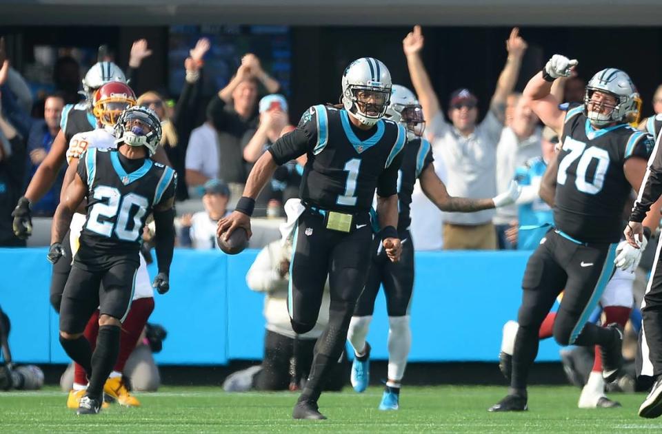 Carolina Panthers quarterback Cam Newton runs to place the ball at midfield following his rushing touchdown during second quarter action against the Washington football team at Bank of America Stadium in Charlotte, NC on Sunday, November 21, 2021.