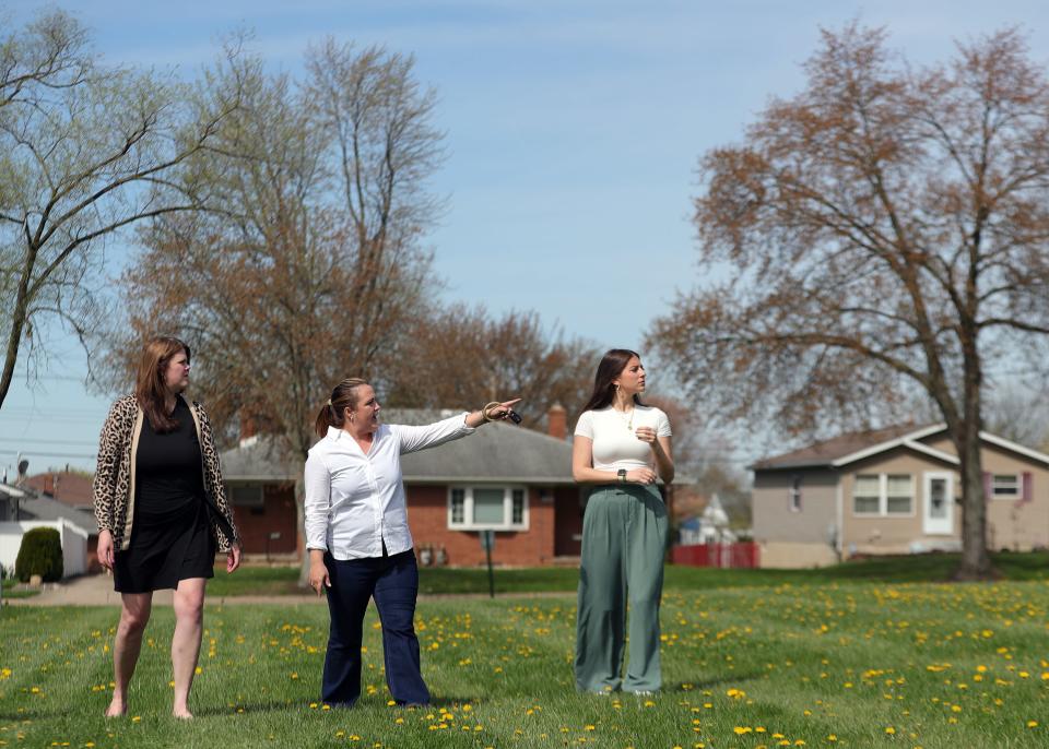 From left, Keep Akron Beautiful's Jacqui Ricchiuti, executive director; Leah Heiser, flowerscape director and arborist; and Emma Segedy, community outreach manager, discuss where trees should be planted April 16 near Voris Elementary School.