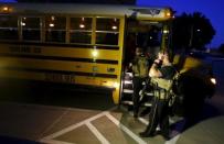 Police officers stand near a school bus used to evacuate attendees of the Muhammad Art Exhibit and Contest sponsored by the American Freedom Defense Initiative after a shooting outside the Curtis Culwell Center where the event was held in Garland, Texas May 3, 2015. REUTERS/Mike Stone