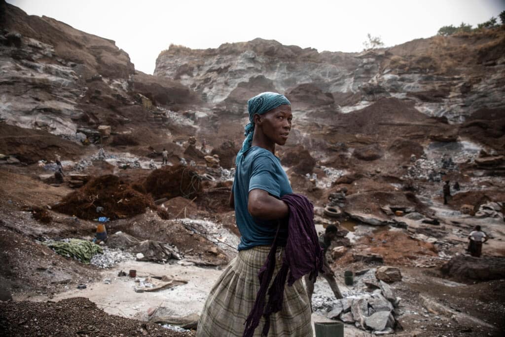 A woman works in a Pissy granite mine in Ouagadougou, Burkina Faso, Monday April 25, 2022. At least 500 displaced people started working at the mine last year making it harder for the original miners to earn a living, said Abiba Tiemtore, head of the site. (AP Photo/Sophie Garcia)