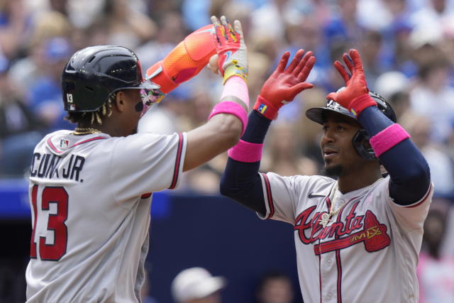 Atlanta Braves second baseman Ozzie Albies, right, celebrates with Ronald Acuna Jr. after his two-run home run against the Toronto Blue Jays during third-inning baseball game action in Toronto, Ontario, Sunday, May 14, 2023. (Frank Gunn/The Canadian Press via AP)