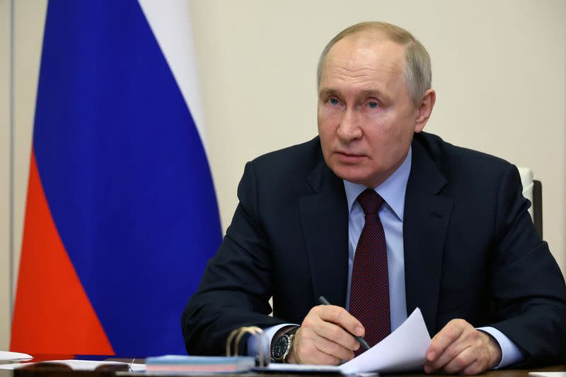 FILE PHOTO: Russian President Putin chairs a meeting outside Moscow