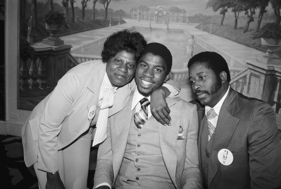 Magic Johnson smiles with his parents after being drafted by the Los Angeles Lakers in 1979. / Credit: Bettmann - Getty Images
