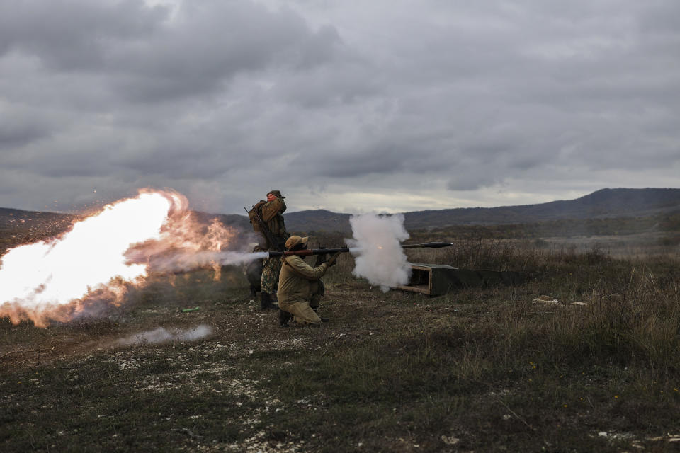 FILE - A recruit fires a Russian man-portable missile during a military training at a firing range in the Krasnodar region in southern Russia, Oct. 21, 2022. Since Russian President Vladimir Putin announced his mobilization on Sept. 21 for the war in Ukraine, independent media, human rights activists and draftees themselves have painted a bleak picture of a haphazard, chaotic and ethnically biased effort to round up as many men as possible and push them quickly to the front, regardless of skill or training. (AP Photo/File)