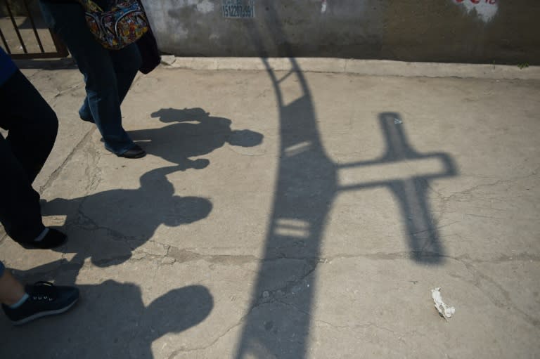 Worshippers pass through the entrance to the "underground" Zhongxin Bridge Catholic Church, in Tianjin, on May 24, 2015