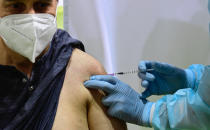 German police officer Dirk Moeller gets an AstraZeneca vaccination against Covid-19 at a new vaccination centre at the former Tempelhof airport in Berlin, Germany, on Monday, March 8, 2021 (Tobias Schwarz / Pool via AP)