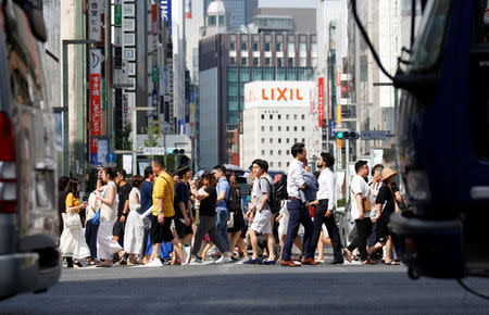 Passersby walk on a street during a heatwave in Tokyo, Japan July 23, 2018. REUTERS/Issei Kato