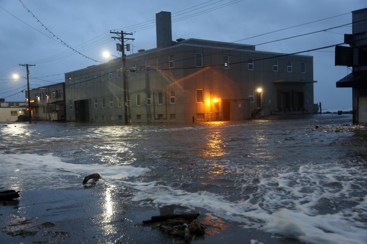 Water rushes down Front Street, just a half block from the Bering Sea, in Nome, Alaska, on Saturday, Sept. 17, 2022. (Peggy Fagerstrom / AP)