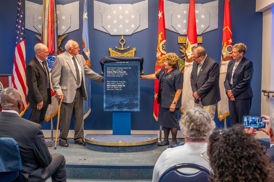 Five people stand on the dais to receive the Medal of Honor at the Pentagon