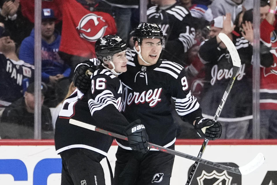 New Jersey Devils' Timo Meier, right, celebrates with teammate Jack Hughes after scoring a goal during the first period of an NHL hockey game against the New York Rangers Thursday, March 30, 2023, in Newark, N.J. (AP Photo/Frank Franklin II)
