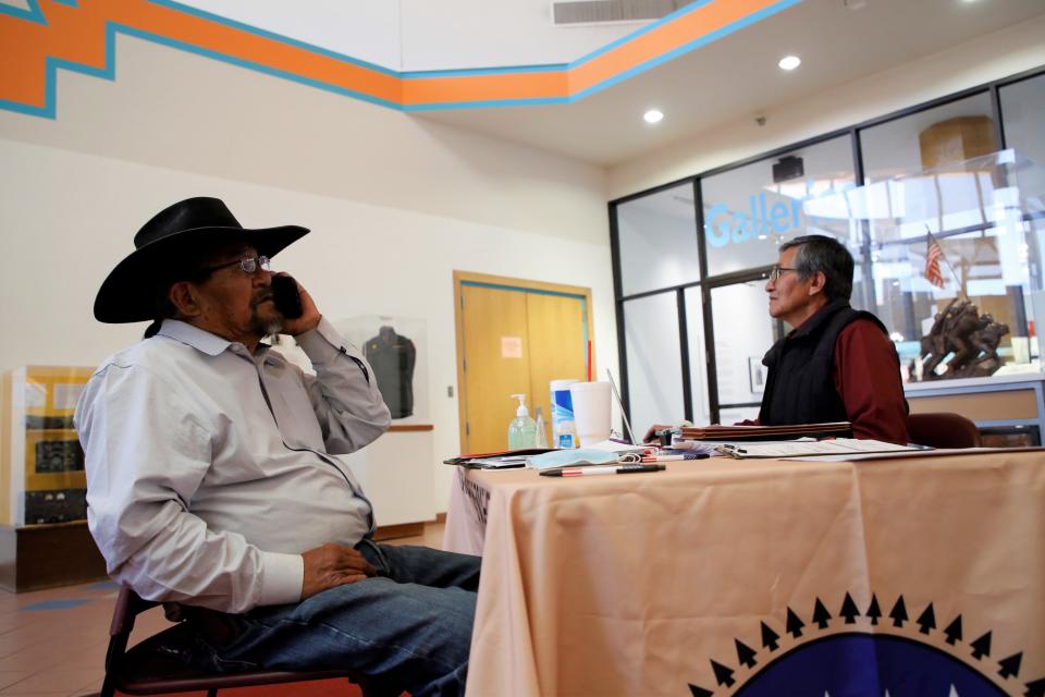 Navajo Board of Election Supervisors Chairperson Melvin Harrison, right, helps Lee Jack Sr. on May 4 file his candidacy form for the Navajo Nation Council to represent Dilkon, Greasewood Springs, Indian Wells, Teesto and White Cone chapters.