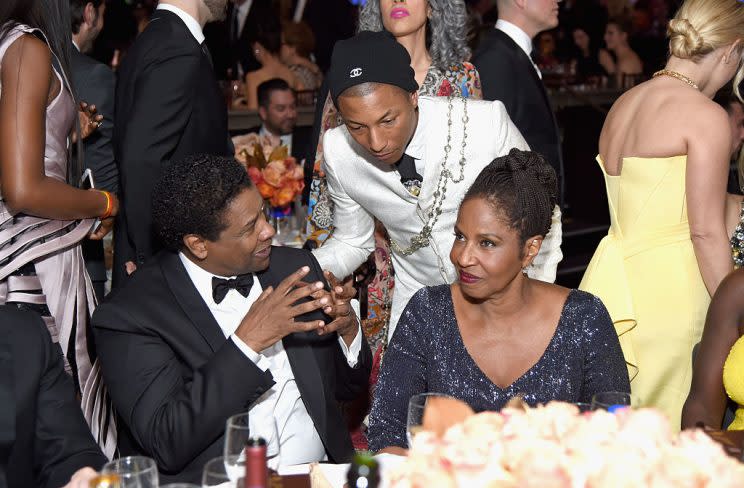 Stars paid their respects to Denzel Washington; here, he's talking to Pharrell. (Photo: Getty Images) 