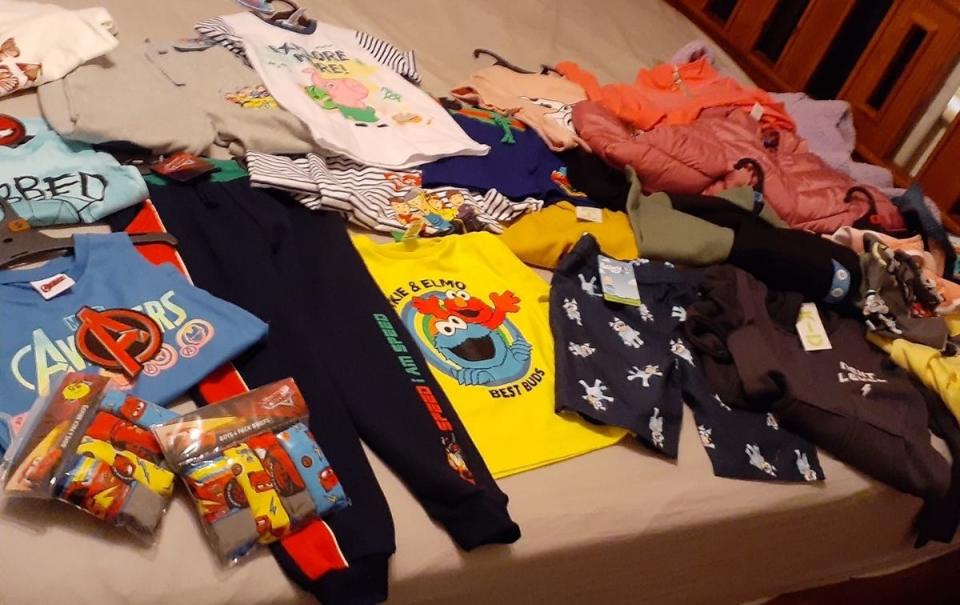 Children's clothes laid out on a bed. Source: Facebook