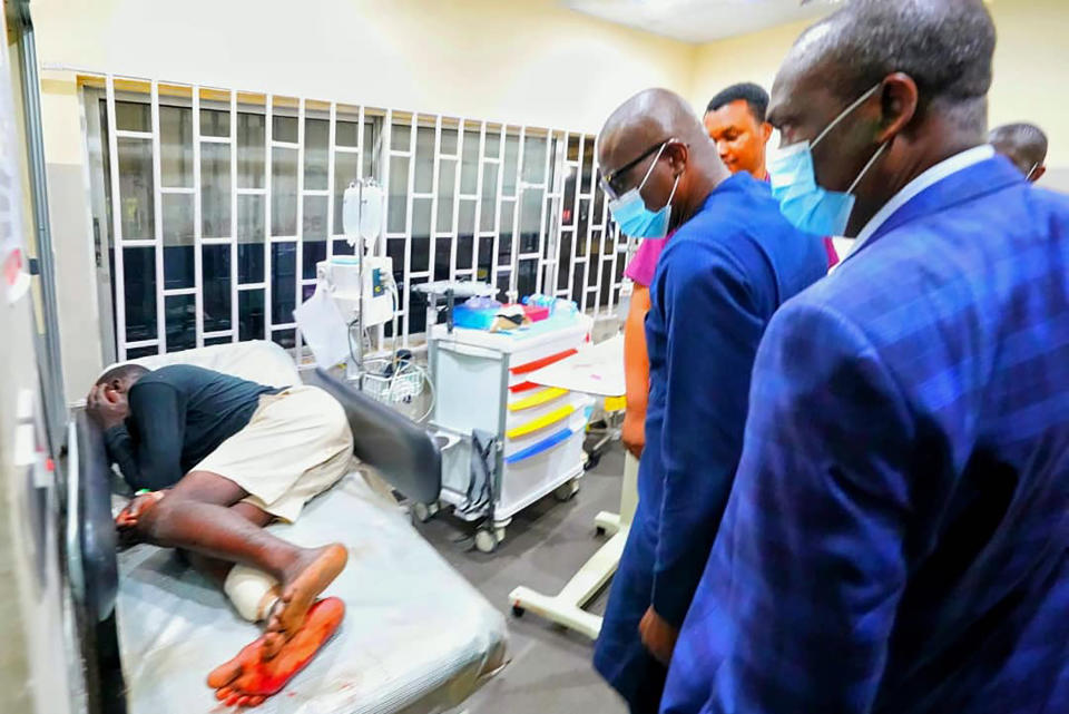 In this photo released by the Lagos State government press, governor Babajide Sanwo-Olu, centre, visit victims injured in last night's protests in a hospital in Lagos, Nigeria, Wednesday Oct. 21, 2020. Nigerians protesting against police brutality stayed on the streets in Lagos on Wednesday, breaking the government curfew following a night of chaotic violence in which demonstrators were fired upon, sparking global outrage. (Lagos State government press Via AP)