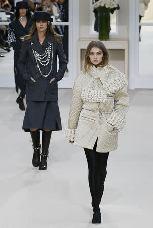 Model Gigi Hadid presents a creation by German designer Karl Lagerfeld as part of his Fall/Winter 2016/2017 women's ready-to-wear collection for fashion house Chanel at the Grand Palais in Paris, France, March 8, 2016. REUTERS/Gonzalo Fuentes