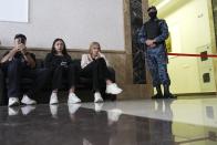 A Russian Federal Bailiffs Service employee guards a corridor leading to a courtroom as journalists sit inside the court in Yekaterinburg, Russia, Thursday, July 18, 2024, during a hearing of Wall Street Journal reporter Evan Gershkovich's suspected spying activities. (AP Photo/Dmitri Lovetsky)