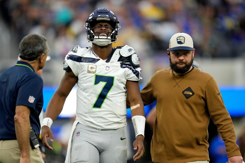 Seattle Seahawks quarterback Geno Smith (7) is helped off the field after an injury during the second half of an NFL football game against the Los Angeles Rams Sunday, Nov. 19, 2023, in Inglewood, Calif.