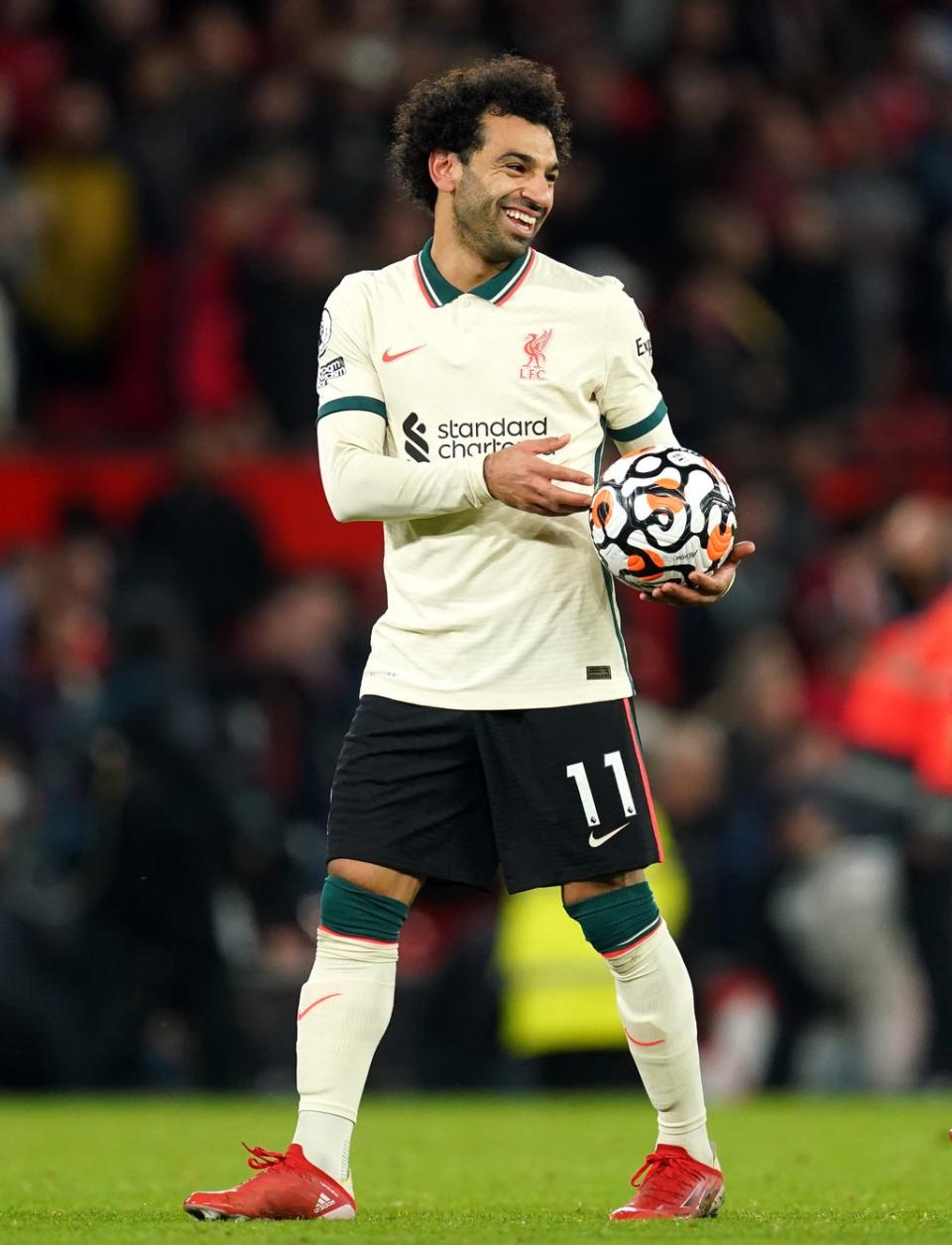 Liverpool hat-trick scorer Mohamed Salah celebrates with the match ball after the final whistle during the Premier League match at Old Trafford, Manchester (Martin Rickett/PA) (PA Wire)