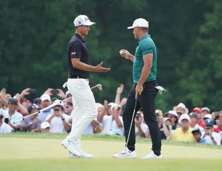 Aug 12, 2018; Saint Louis, MO, USA; Brooks Koepka (right) shakes hands with Adam Scott on the 18th green during the final round of the PGA Championship golf tournament at Bellerive Country Club. Mandatory Credit: Jerry Lai-USA TODAY Sports