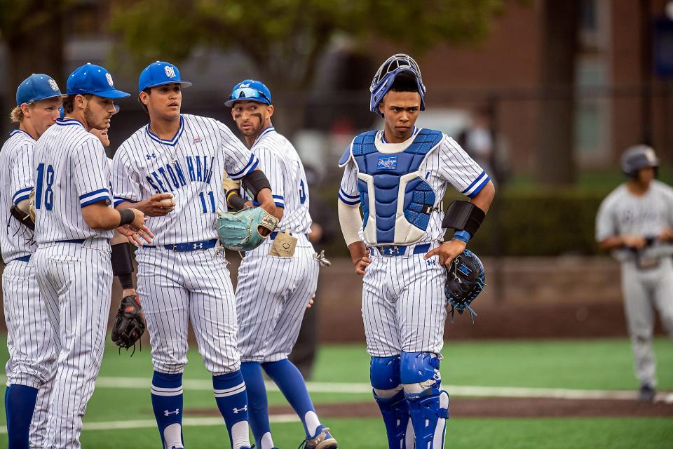 Seton Hall baseball catcher Jedier Hernandez (right) thinks things over with pitcher Nick Payero (11)