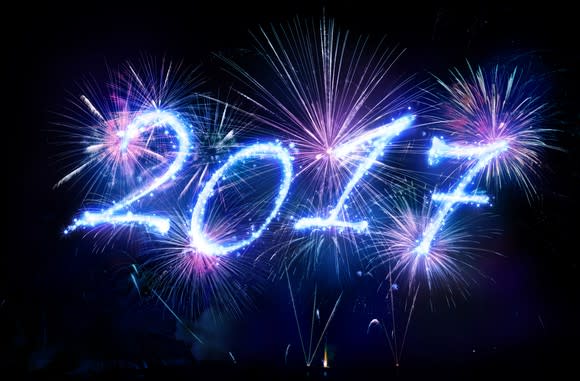 Numbers 2017 spelled out in sparklers, with fireworks.