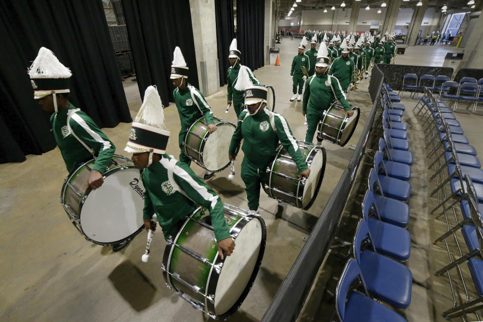 The drum line of the Mississippi Valley State University marching band files into the venue from the loading dock before the start of the 2023 National Battle of the Bands, a showcase for HBCU marching bands, held at NRG Stadium, Saturday, Aug. 26, 2023, in Houston. (AP Photo/Michael Wyke)