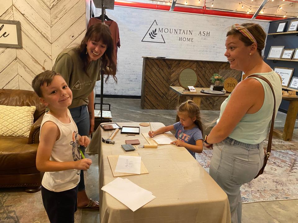 Mountain Ash Home store owner, Cassie Benzinger, left, helps Liam and Bella Winnie make a gift for their dad, Daniel, for Father's Day. Their mom Allison Winnie also found the gift option while coming to a recent workshop at the store.