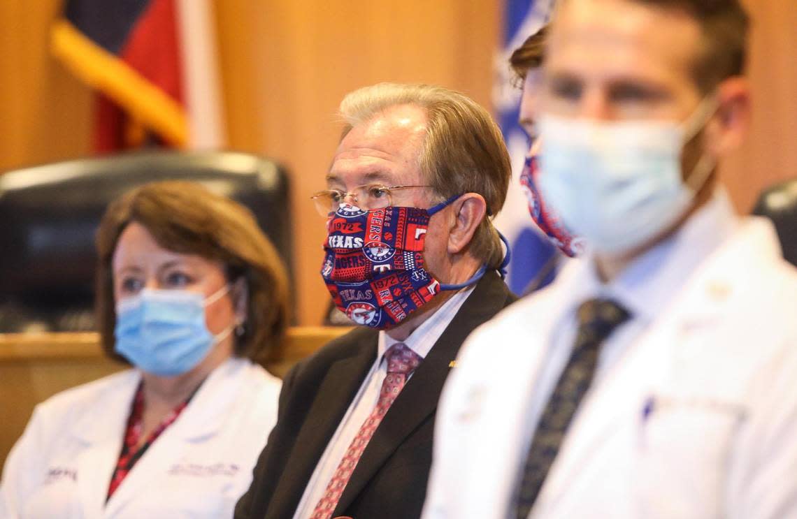 Judge Glen Whitley, center, attends a press conference during the 2020 COVID-19 pandemic that announced that patrons at all Tarrant County businesses and outdoor gatherings were required to wear masks.